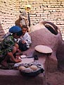 Woman kneadling dough to make flat cakes.