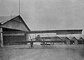 On the Aerodrome. Airplane with Pilots near a Hangar