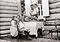  Peasant Family (Father and Children) in the Yard of their House listen to Gramophone (is standing on the table covered with the table-cloth)